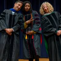 Faculty with award posing with Provost